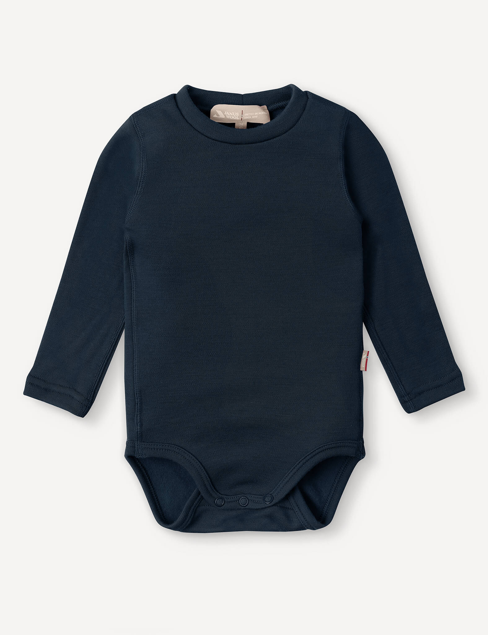 The Body – Merino Baby AirWool in navy is a long-sleeve merino wool bodysuit featuring snap buttons at the bottom for easy changing and offering breathable insulation, shown against a white background.