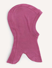 The Balaclava – Merino Kids AirWool, crafted from soft pink merino wool, is shown laid flat on a light background. It features a face opening and a flared bottom edge.