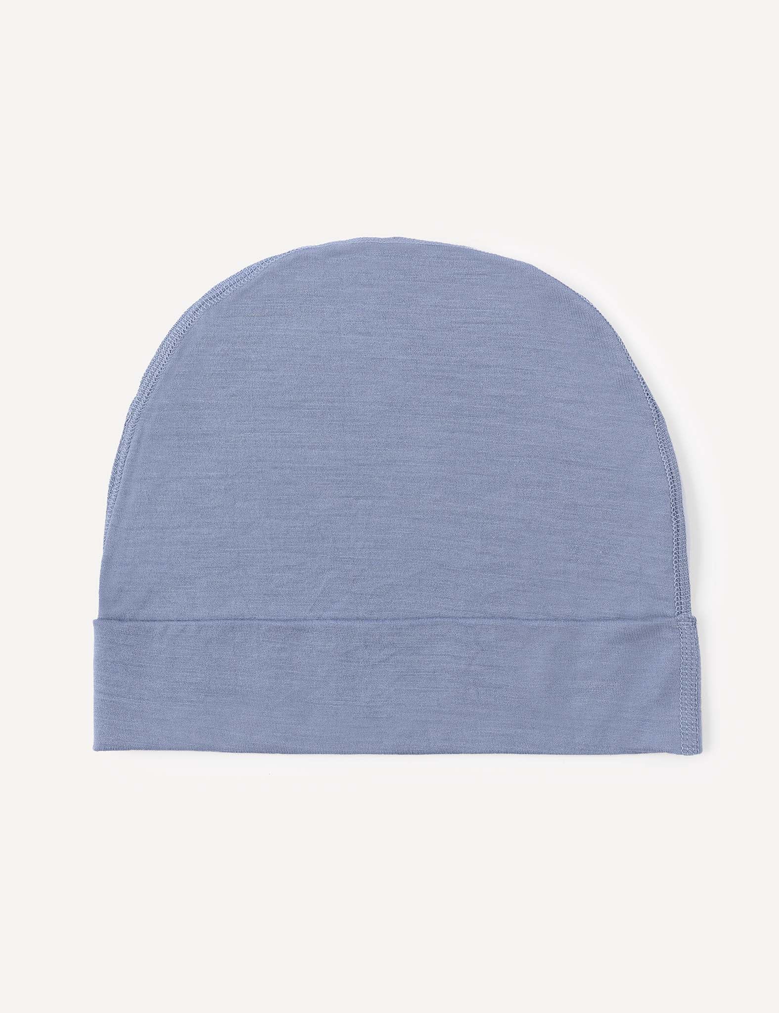 The Beanie – Merino Kids Light, a soft and lightweight wool beanie in plain light blue, is laid flat on a plain white background.