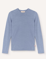 A Crewneck – Merino Kids Light shirt in Troposphere, featuring long sleeves and a crew neckline, is displayed laid flat on a plain background. Made from soft merino wool, the shirt has a simple design without visible patterns or logos, except for a small red tag on the lower side seam.