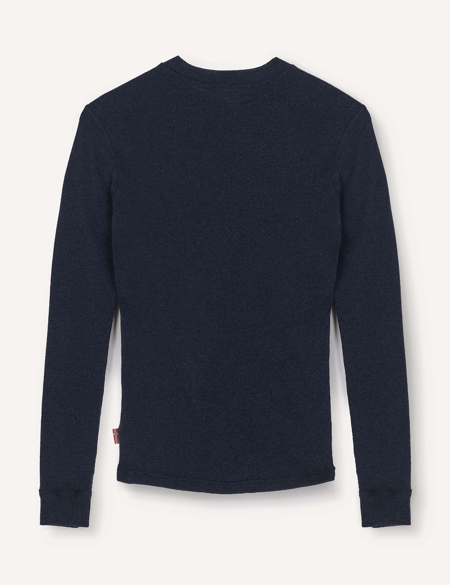 The Crewneck – Merino Kids Classic Rib, a long-sleeve dark navy blue ribbed wool jersey shirt, is shown from the back laid flat on a light background.