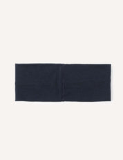 The Headband – Merino Kids Light is a wide, rectangular headband in navy blue merino wool, displayed flat on a light background with a clearly visible seam centered on the band.