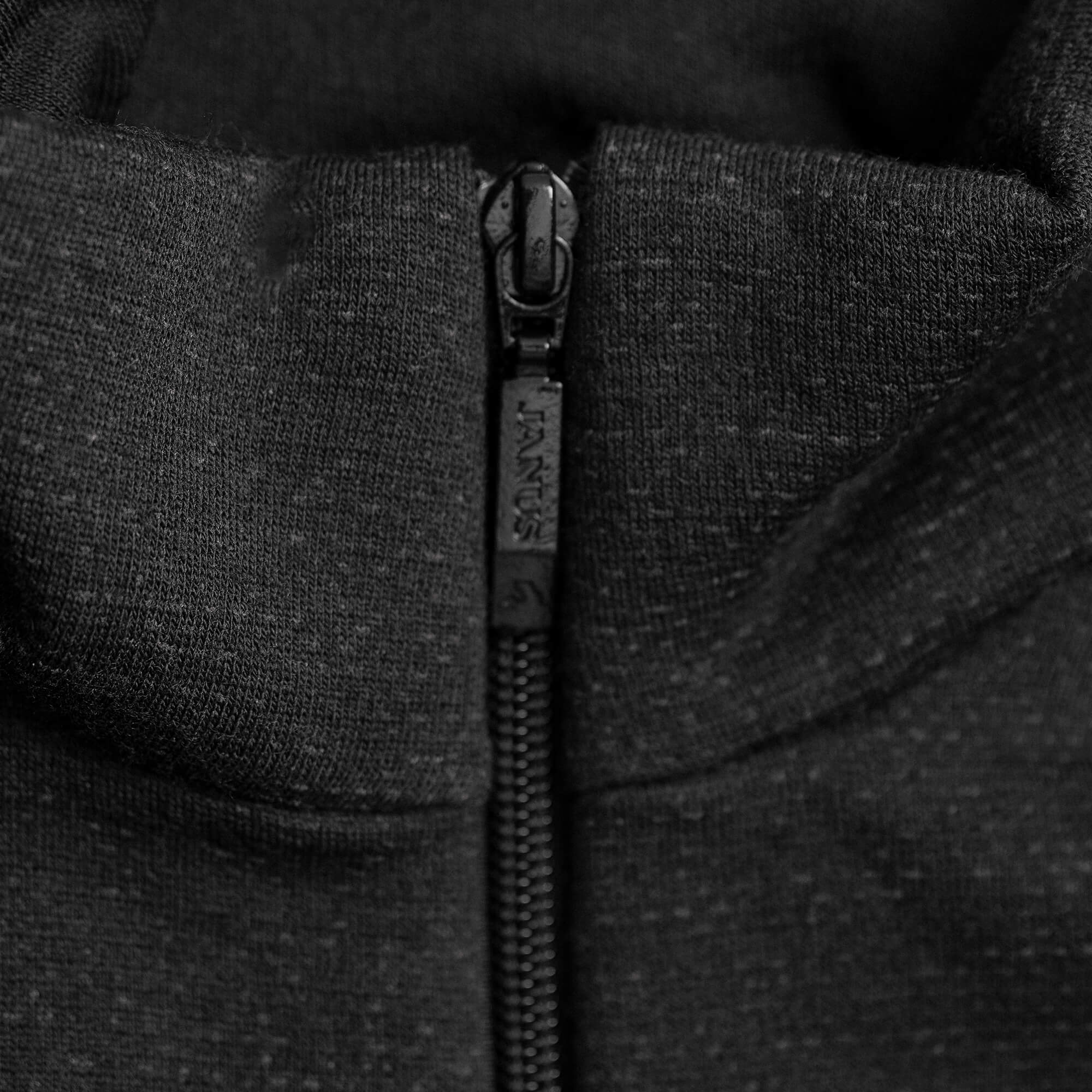 Close-up of a black YKK zipper partially zipped on the dark Jacket Merino – AirWool 350 Women, showcasing the warmth and style of its premium Merino wool design.