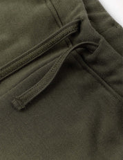 Close-up of the Sweatpants – Merino Kids AirWool in olive green, highlighting the drawstring and pocket detail, visible stitching, and soft merino wool fabric texture.