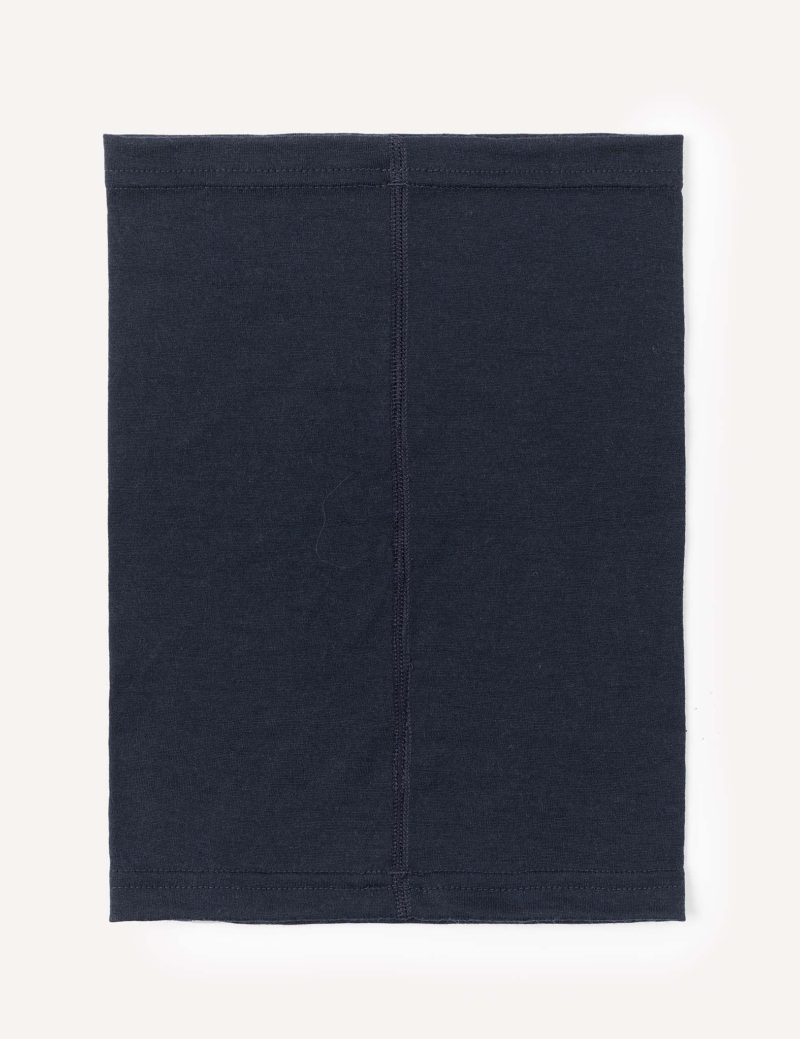 A rectangular black Merino Kids Light Neckwarmer made from merino wool, featuring visible stitching down the middle, is laid flat on a light background.