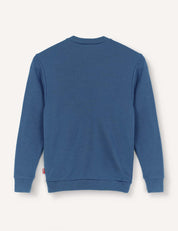 The Pullover – Merino Kids AirWool in blue is shown from the back, featuring long sleeves, a crewneck design, and ribbed cuffs and hem, displayed on a plain white background.