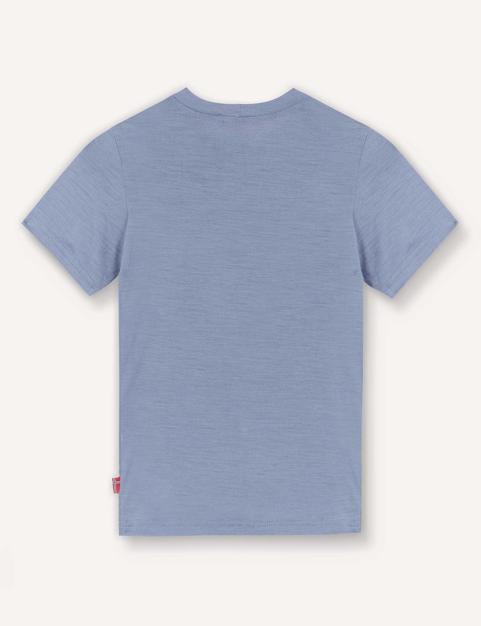 The T-Shirt – Merino Kids Light is shown from the back against a white background, featuring a plain light blue design with short sleeves made from merino wool for natural temperature regulation and all-day comfort.